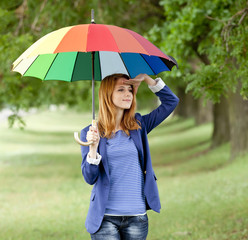 Young fashion girl with umbrella at spring outdoor.