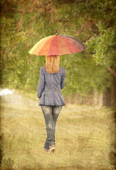 Young fashion girl with umbrella at spring outdoor.