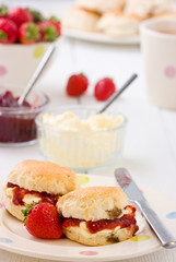 Home-baked scones strawberry jam, clotted cream strawberries.