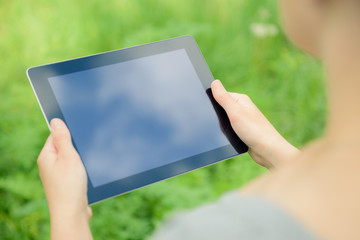 Holding digital tablet in hands