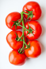 six tomatoes on the green branch