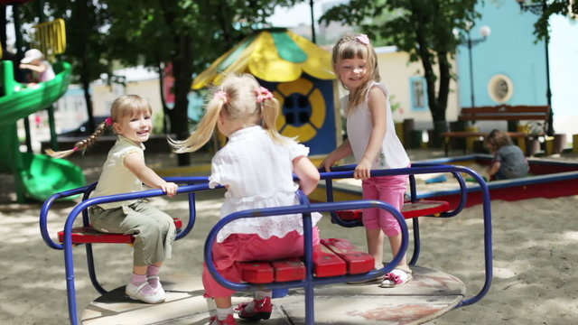 Three happy girls on the playground