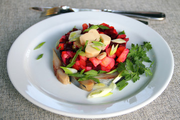 Salad with cooked vegetables, mushrooms and herring