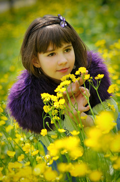 beautiful girl enjoying a day in a field of canola flowers.