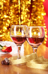 Two glass with champagne with burning candles