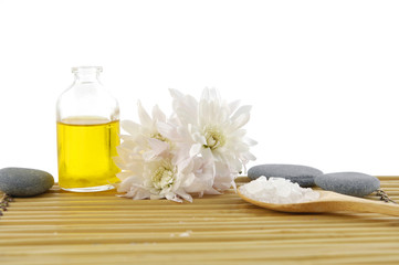 Obraz na płótnie Canvas massage oil and salt in spoon with perfume bottle on mat