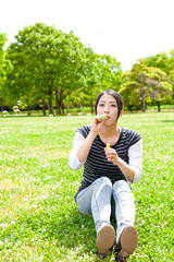 Naklejka na ściany i meble young asian woman with soap bubble in the park