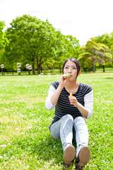 Naklejka na ściany i meble young asian woman with soap bubble in the park