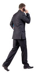 Obraz premium back view of walking business man
