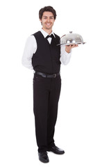 Portrait of a butler with bow tie and tray