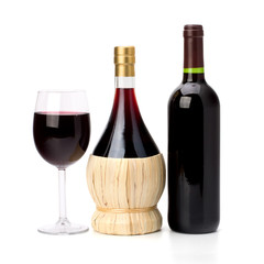 Full red wine glass goblet and bottle