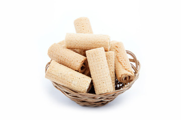 Crispy cinnamon rolls in a basket on a white background.