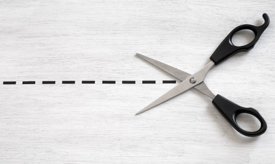 Scissors cutting along the dotted line