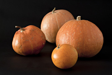 Set of pumpkins on black.