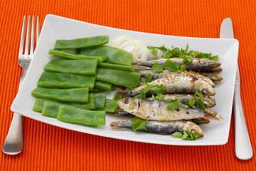 fried sardines with boiled green beans and onion