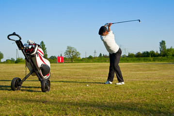 golfer and golf bag on driving range