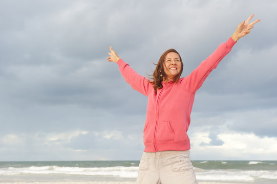Happy confident mature woman at beach