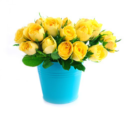Beautiful bouquet of yellow roses in a blue bucket