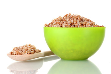 Boiled buckwheat in a green bowl isolated on white