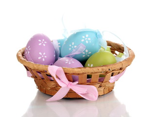 Colorful easter eggs in basket isolated on white