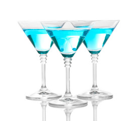 Blue cocktail in martini glasses isolated on white