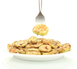 Fried zucchini in a white plate with fork