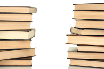 Two towers of books on white background close-up