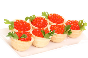 Red caviar in tartlets on white plate isolated on white