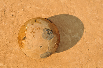 old soccer ball on ground