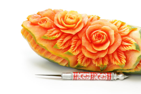 Carved papaya fruit and knife the art of Thailand