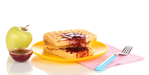 Tasty waffles with jam on plate isolated on white