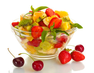 glass bowl with fresh fruits salad and berries isolated on