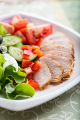 Chicken fillet with vegetable salad on a plate