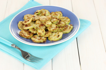 roasted squash in a blue bowl with fork