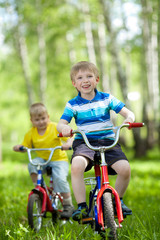 Fototapeta premium little children riding their bikes