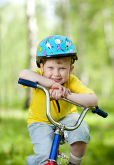 Fototapeta na wymiar nice kid weared in helmet on bicycle