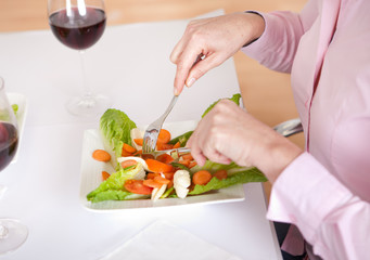 Obraz na płótnie Canvas Woman eating salad at home