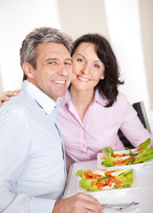 Mature couple having lunch at home