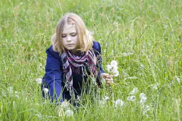 Fototapeta premium little girl on the meadow in spring day