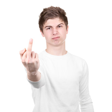 Angry teenager shows rude gesture on a white background