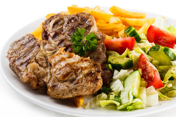 Grilled steak, French fries and vegetables