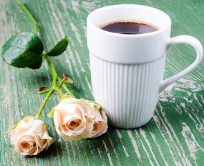 Fototapeta na wymiar Сup of coffee with sprig roses