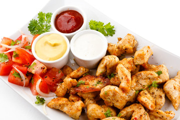 Grilled meat and vegetables on white background
