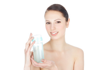 Beautiful young brunette woman holding a tonic for the face