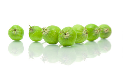 unripe green apples on white background