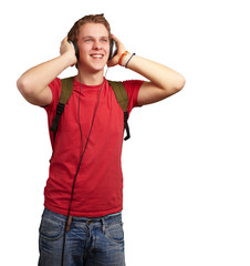portrait of cheerful young student listening music with headphon