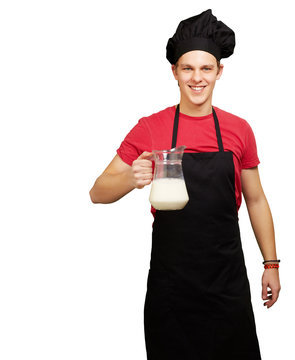 portrait of young cook man holding milk jar over white backgroun