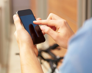 Young man touching a modern mobile, closeup
