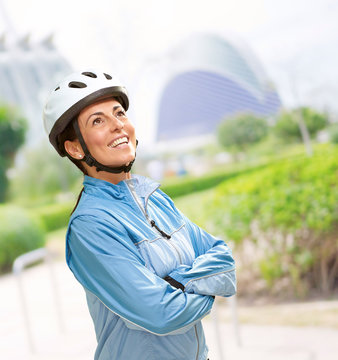 portrait of a sporty middle aged woman wearing a bicycle helmet
