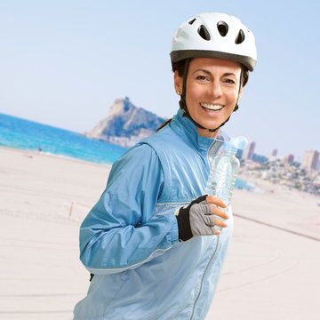 portrait of cyclist middle aged woman holding a water bottle in